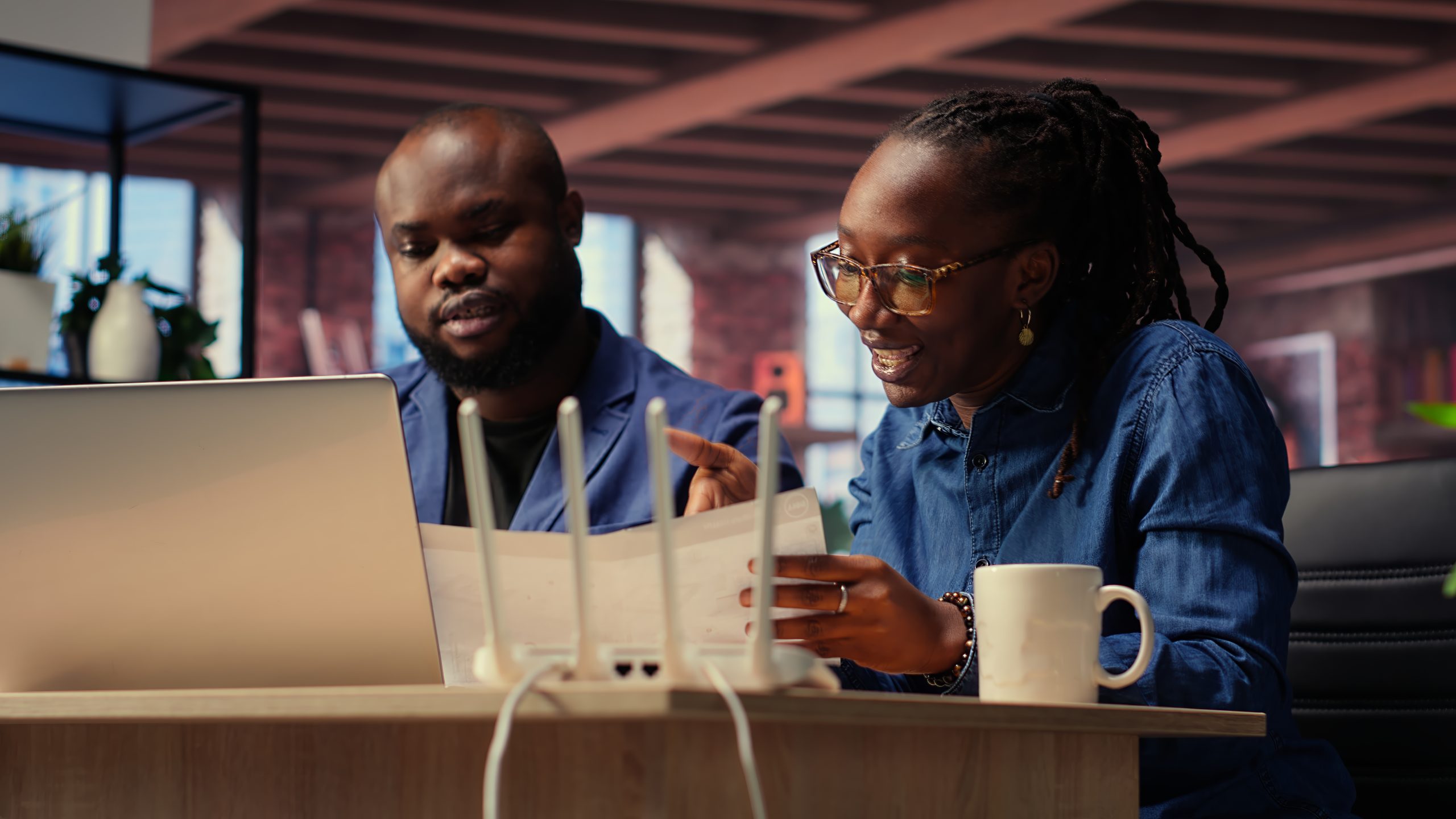 black irritated man and woman rebooting their wireless router